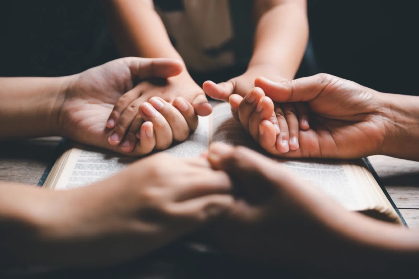 Hands raised in prayer at New Wine Church